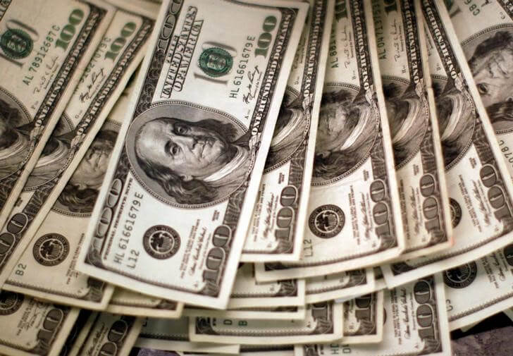 Dollar to hold steady in the year ahead, risks to the downside: Reuters poll