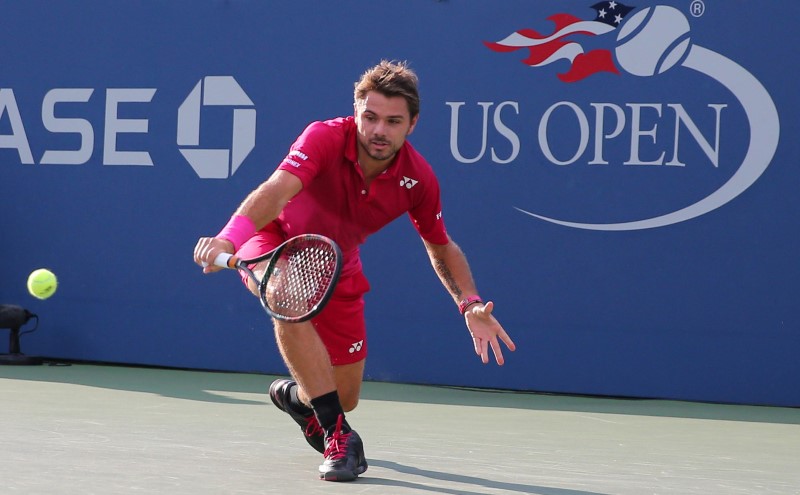 Wawrinka saves match point to beat unseeded Evans