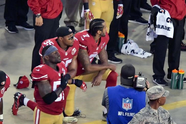 More kneeling players, raised fists, in anthem protests