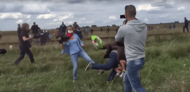 VIDEO: Camerawoman trips running refugee carrying child