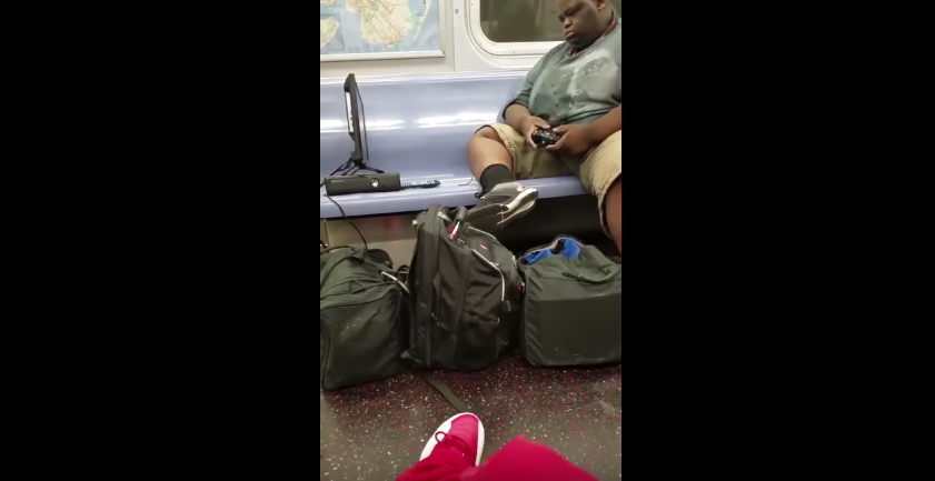 Watch this man play Xbox on the NYC subway and not care what you think