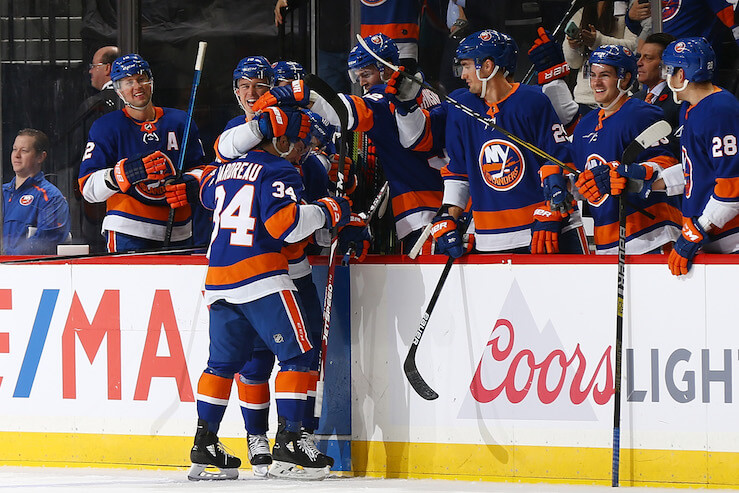 The Islanders bench celebrates with Cole Bardreau (34) after he scored his first-career NHL goal on Tuesday night. (Photo: Getty Images)