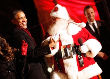 President Barack Obama greets Santa Claus while on stage during the 2014 National Christmas Tree Lighting Ceremony at President's Park on December 4, 2014 in Washington, DC.