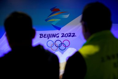 Staff members work near the emblem for Beijing 2022 Winter Olympics displayed at the Shanghai Sports Museum in Shanghai
