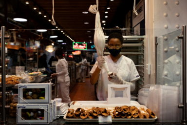 FILE PHOTO: A worker fills a cannoli at a bakery at Reading Terminal Market in Philadelphia
