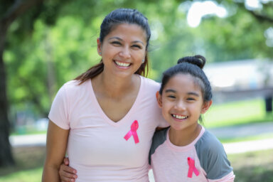 Filipino mother and daughter wearing breast cancer awareness pink ribbons