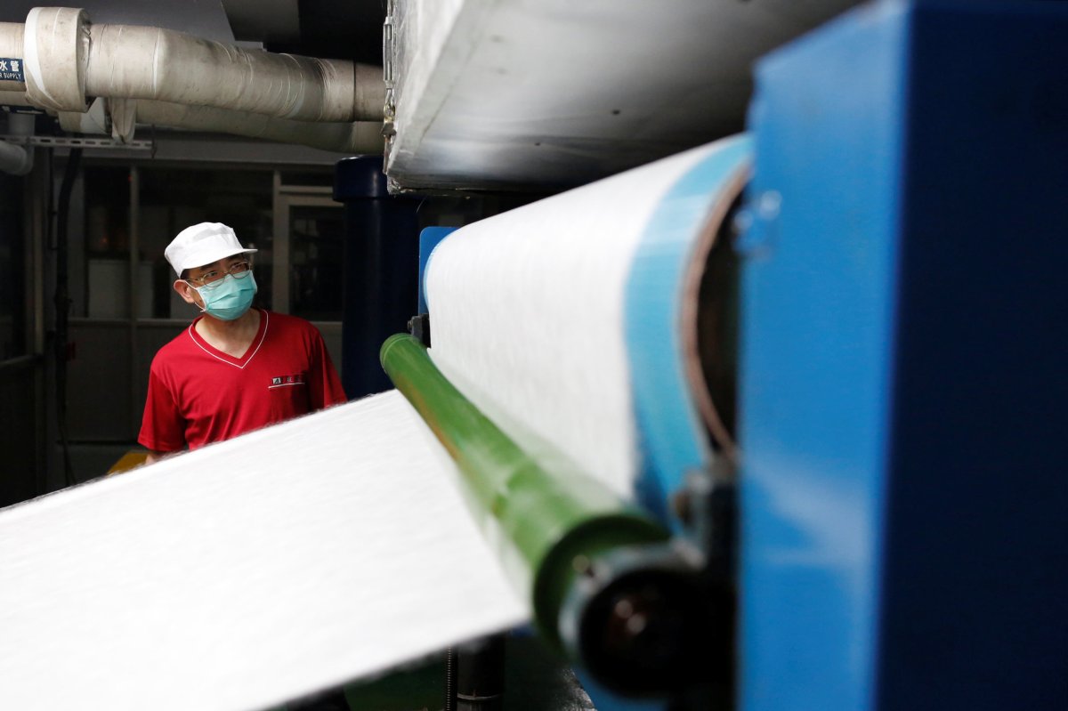 Staff member works inside a non woven filter fabric factory,