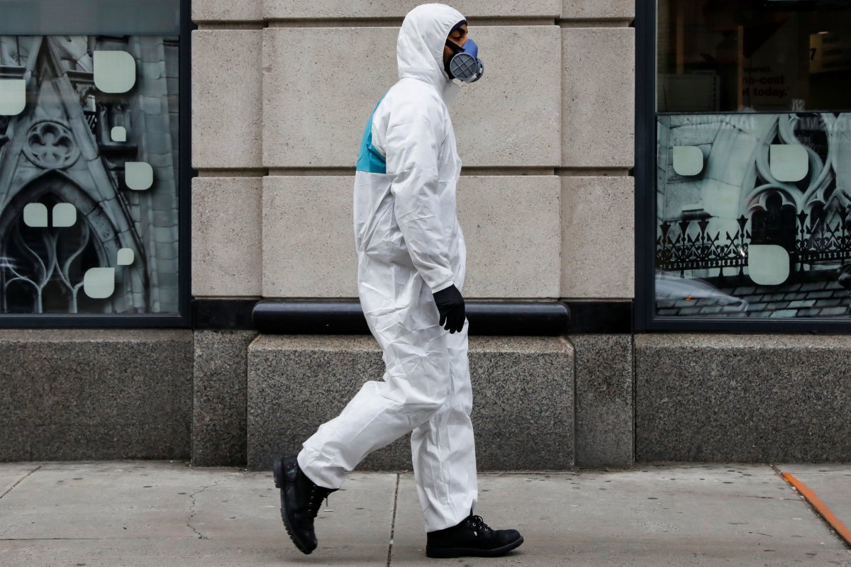 A man wears personal protective equipment (PPE) as he walks