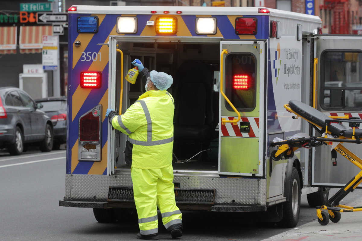 Worker sprays disinfectant in ambulance at Brooklyn Hospital Center during