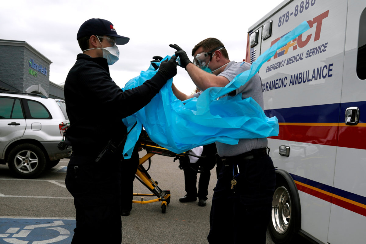 FILE PHOTO:  REACT EMS paramedics put on protective gear