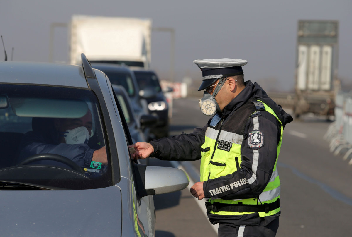 FILE PHOTO: Police check cars at one of the exits