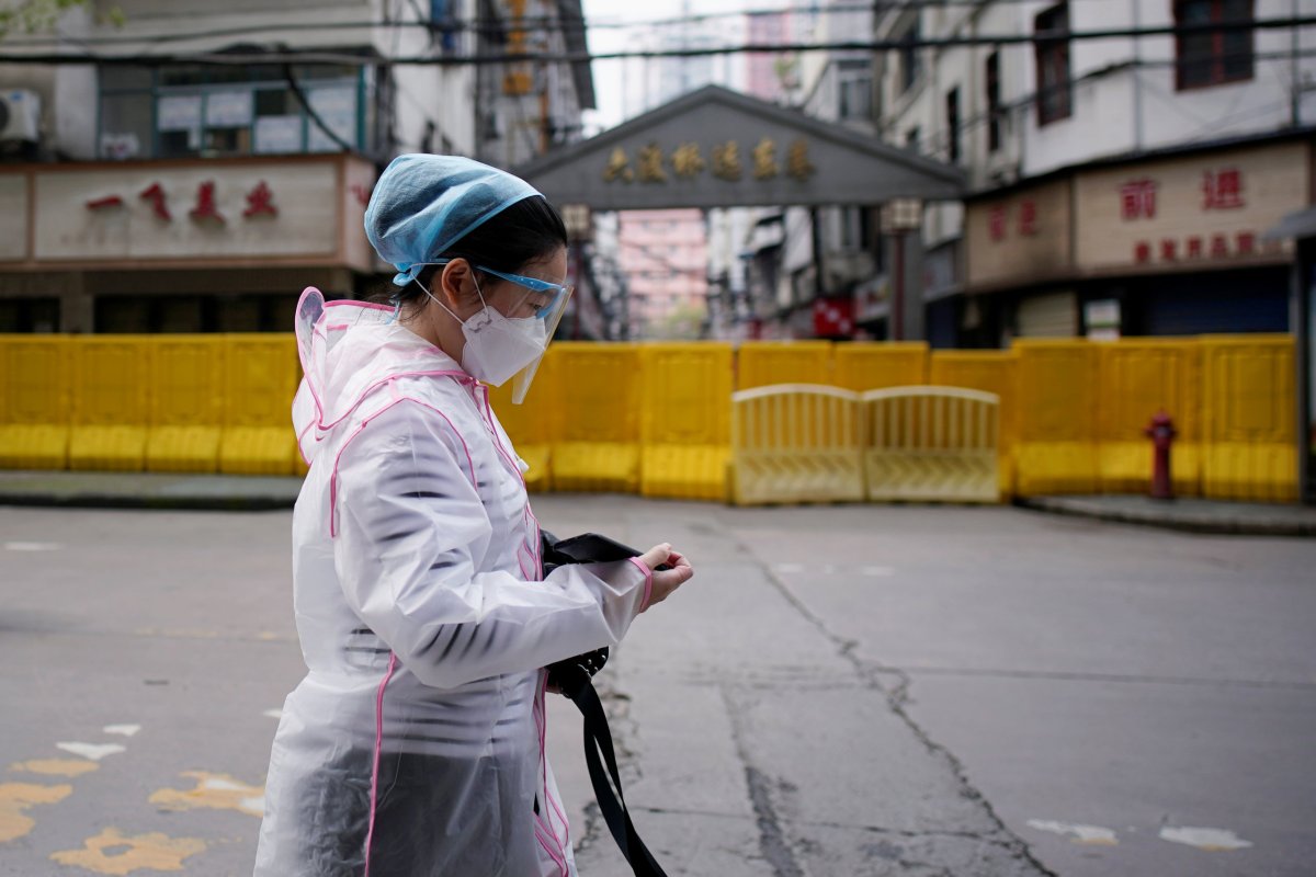 A woman wearing a face mask walks at a residential