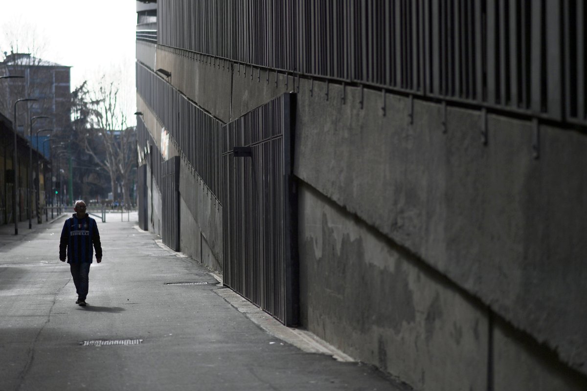 A man walks outside the San Siro stadium after the