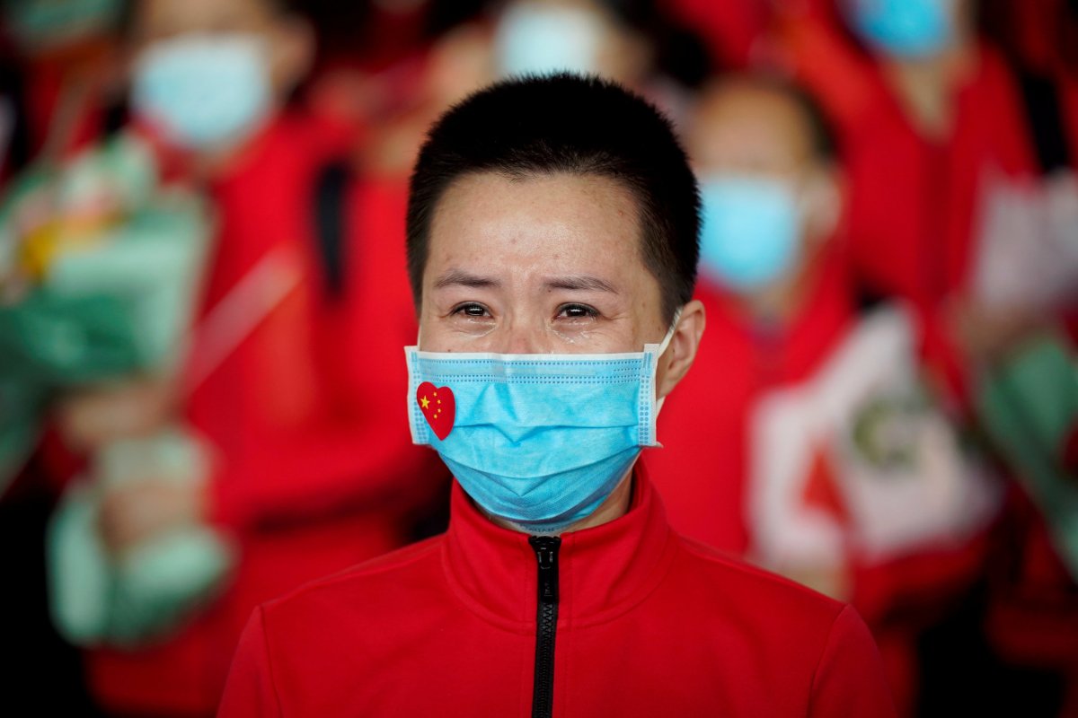 Member of a medical team weeps at the Wuhan Tianhe