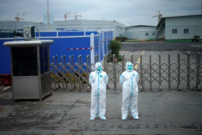 Workers in protective suits are seen at the Leishenshan Hospital,