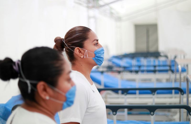 FILE PHOTO: Two nurses wearing protective masks pose inside the