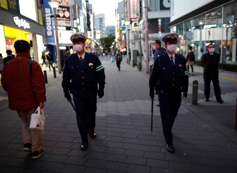 FILE PHOTO:  Police officers wearing protective face masks patrol