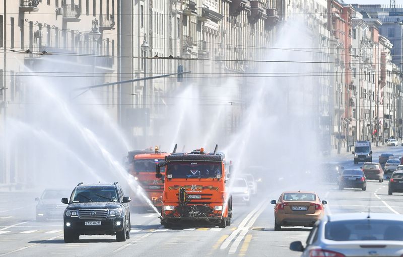 Vehicles spray disinfectant while sanitizing a road amid the outbreak