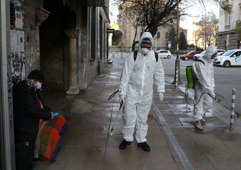 Workers spray disinfectant outside St Petka church
