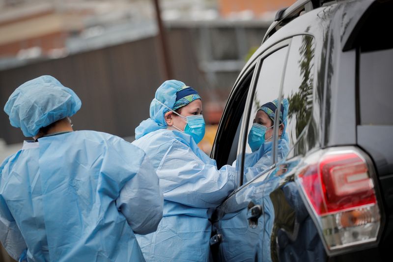 Nurses work at a drive-thru testing site for the coronavirus