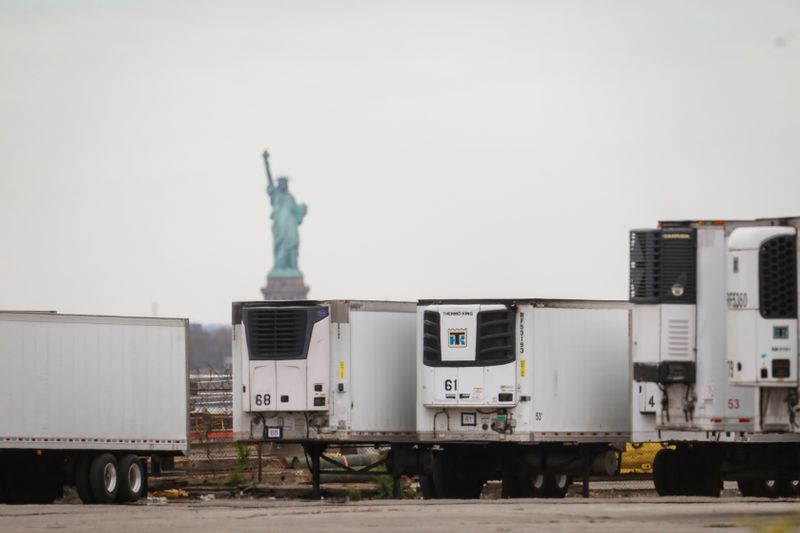 FILE PHOTO: Refrigerated tractor trailers used to store bodies of