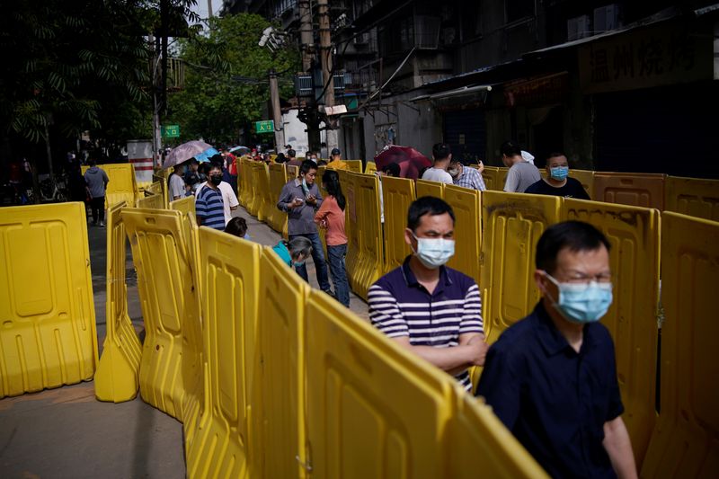 Residents wearing face masks line up for nucleic acid testings
