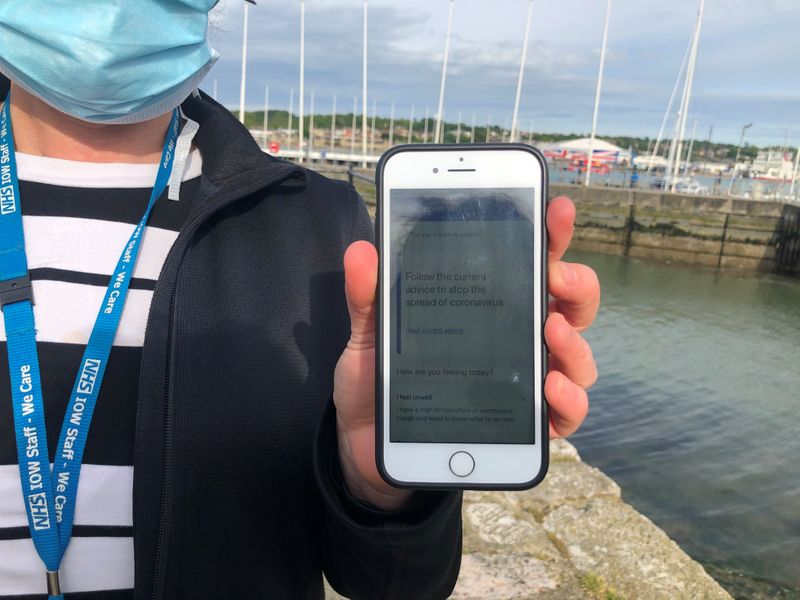 UK National Health Service employee Anni Adams shows a smartphone