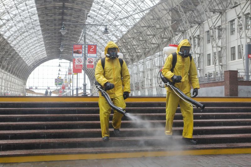 Emergencies Ministry members sanitize a railway station amid the outbreak