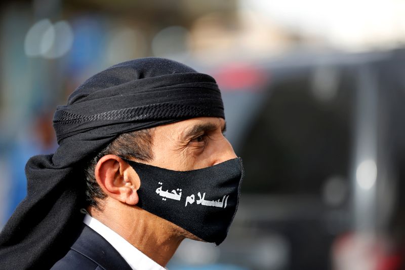 FILE PHOTO: A man wears a mask as he walks