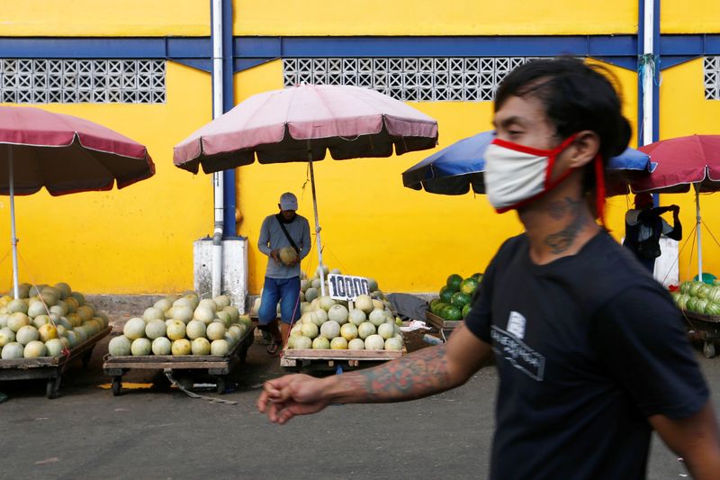 FILE PHOTO: A vendor sells melons at a traditional market