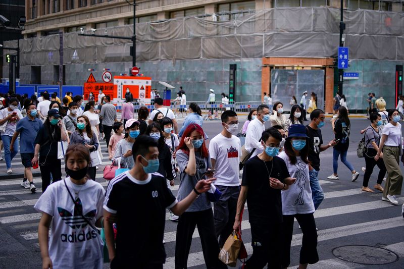 People wearing protective face masks are seen on a street