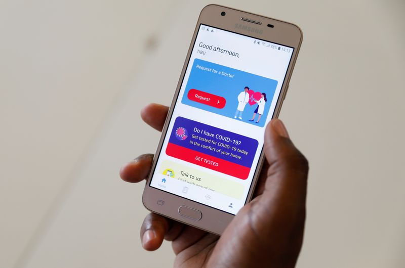 A man displays the TIBU Health app of the Nairobi-based