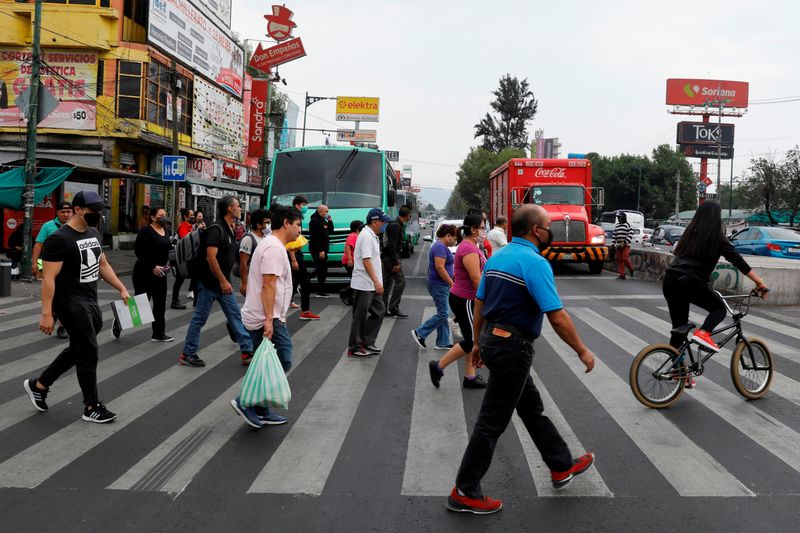 People cross a road in the municipality of Iztapalapa as