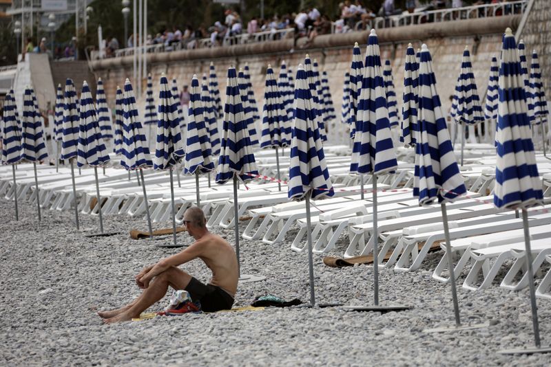 Beach umbrellas are aligned in Nice