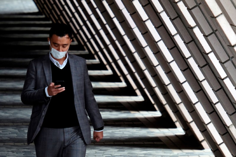 A man wears a protective mask as he walks at