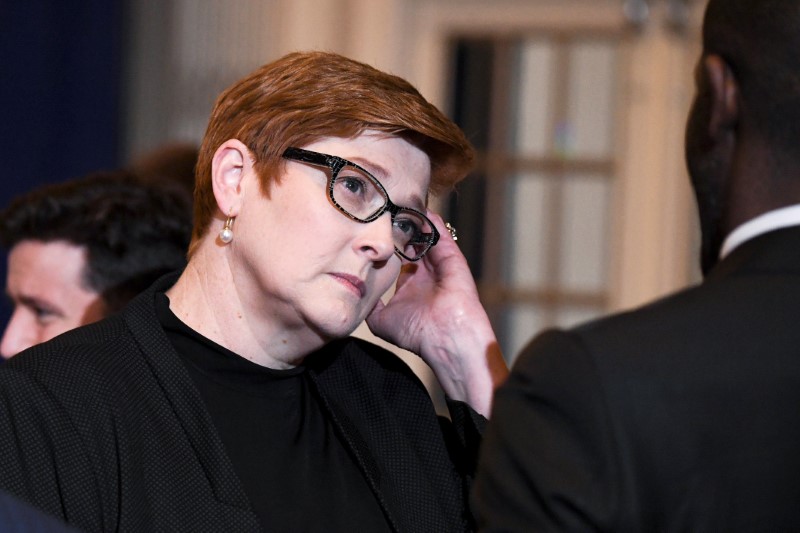 Australian Foreign Minister Marise Payne speaks with a delegate from