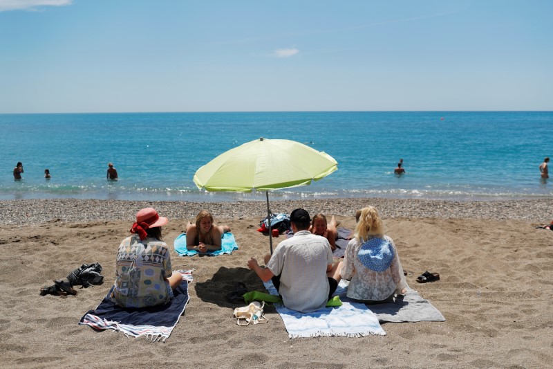 People enjoy on La Malagueta beach as some Spanish provinces