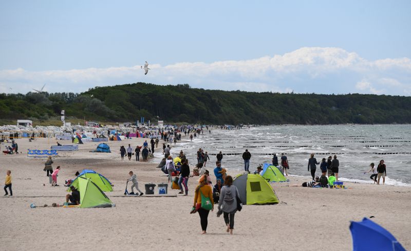 FILE PHOTO: People enjoy the day at the Warnemuende beach,