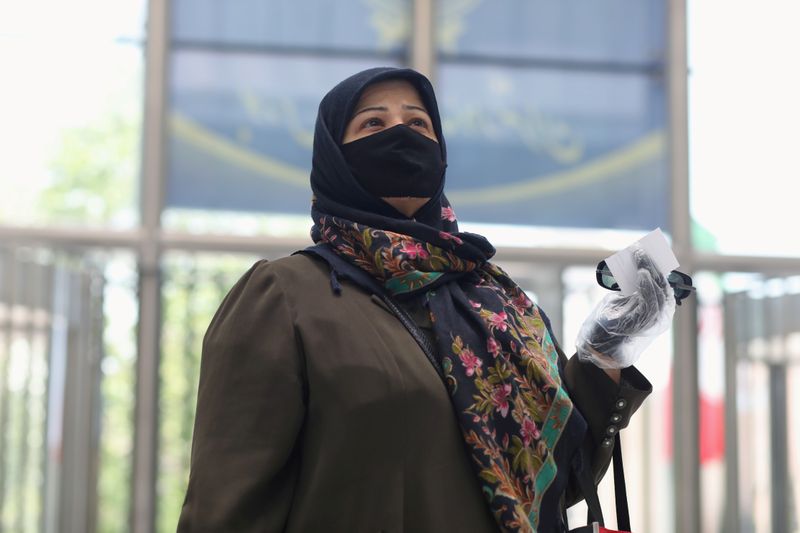 FILE PHOTO: A woman wearing a protective face mask and