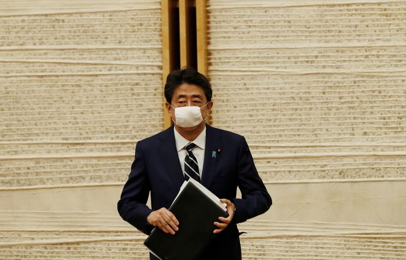 Japan’s Prime Minister Shinzo Abe leaves venue after a news