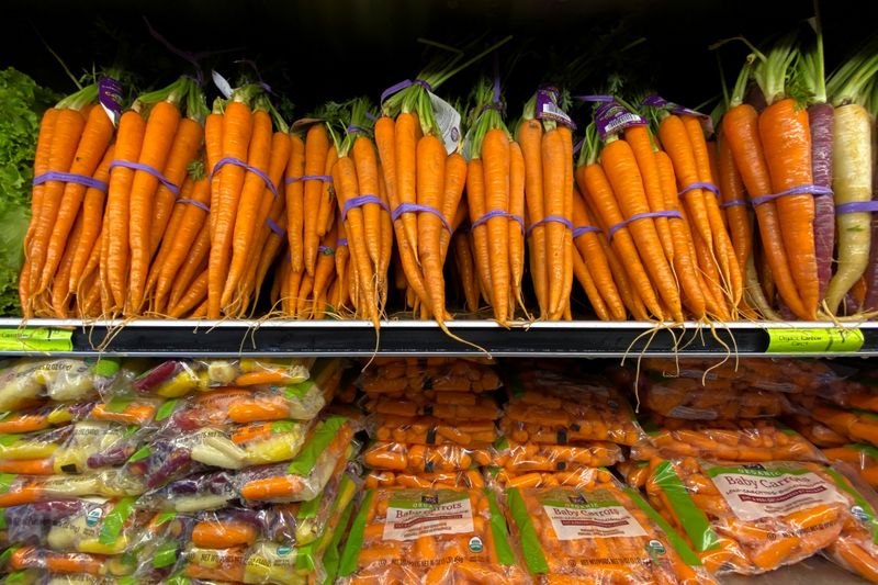 Fresh carrots are shown for sale at a grocery store