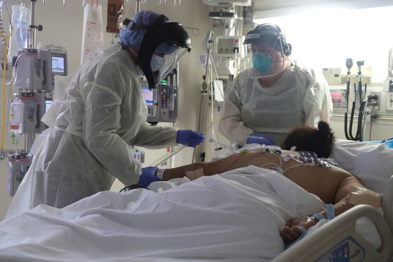 FILE PHOTO: Medical staff attend to a patient suffering from