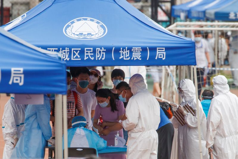 People line up to get tested at the Guangan Sport