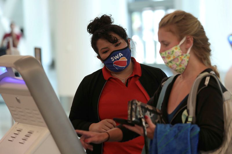 FILE PHOTO: A Southwest Airlines Co. employee wears a protective