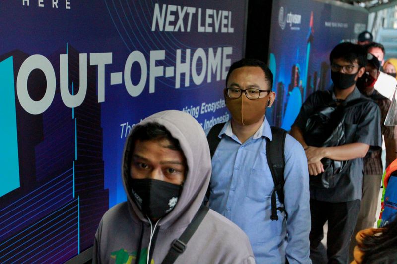 Passengers are seen wearing a protective face mask at a
