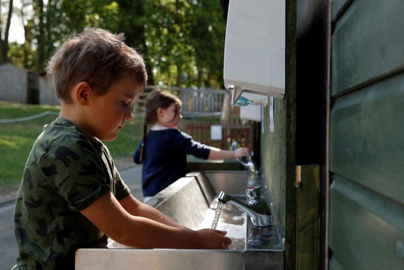 FILE PHOTO: Children are seen washing their hands at Heath