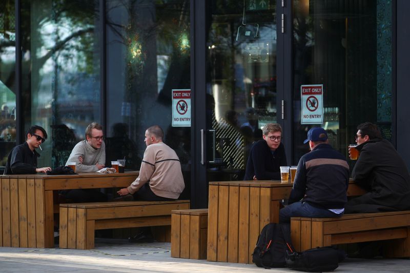 People socialise while drinking alcohol, in London