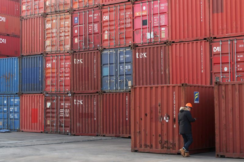 FILE PHOTO: Worker checks containers at a logistics center near