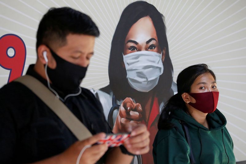 FILE PHOTO: People are seen wearing protective face masks at