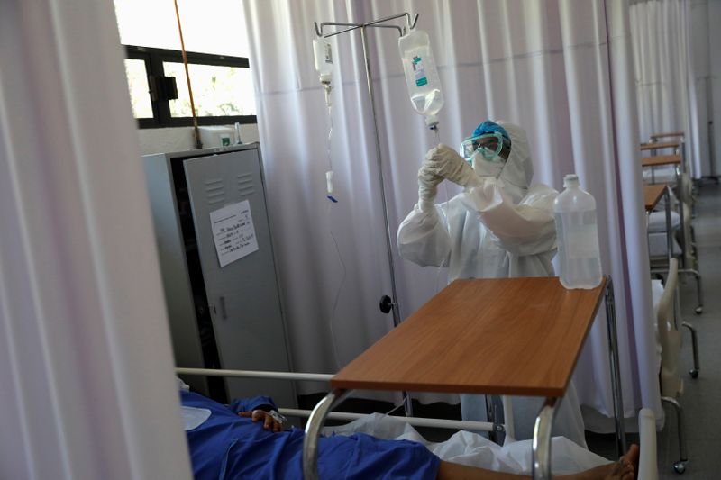 FILE PHOTO:  A medical staff is seen looking after